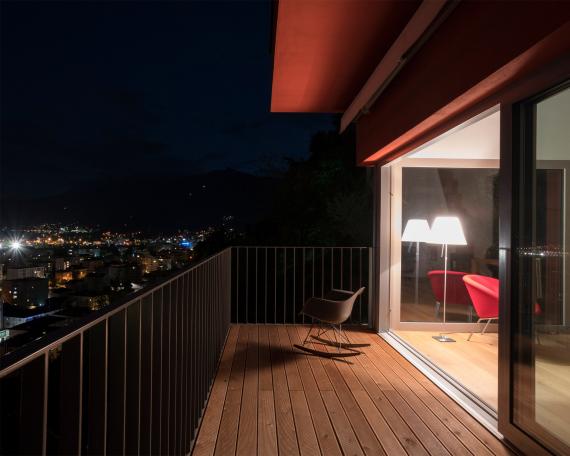 Conversion of holiday home Casa Sogno Mio, Locarno View from balcony into the living room through the lift doors by night