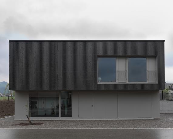 House Wangen_3_North façade, vertical wooden slat façade with pre-greying and metal railings as Juliet balconies