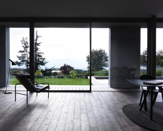 View from the living room towards Lindenberg hill and the pool by Woodtli Schwimmbadtechnik 