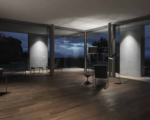 Corner lift-and-slide windows by Huber Fenster, looking out towards the covered seating area and the surrounding landscape 