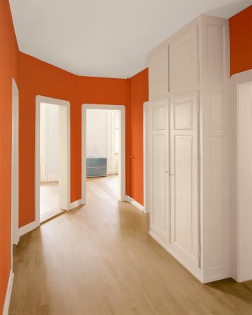 Apartment Zurich hallway in orange and painted skirting and door jambs in beige